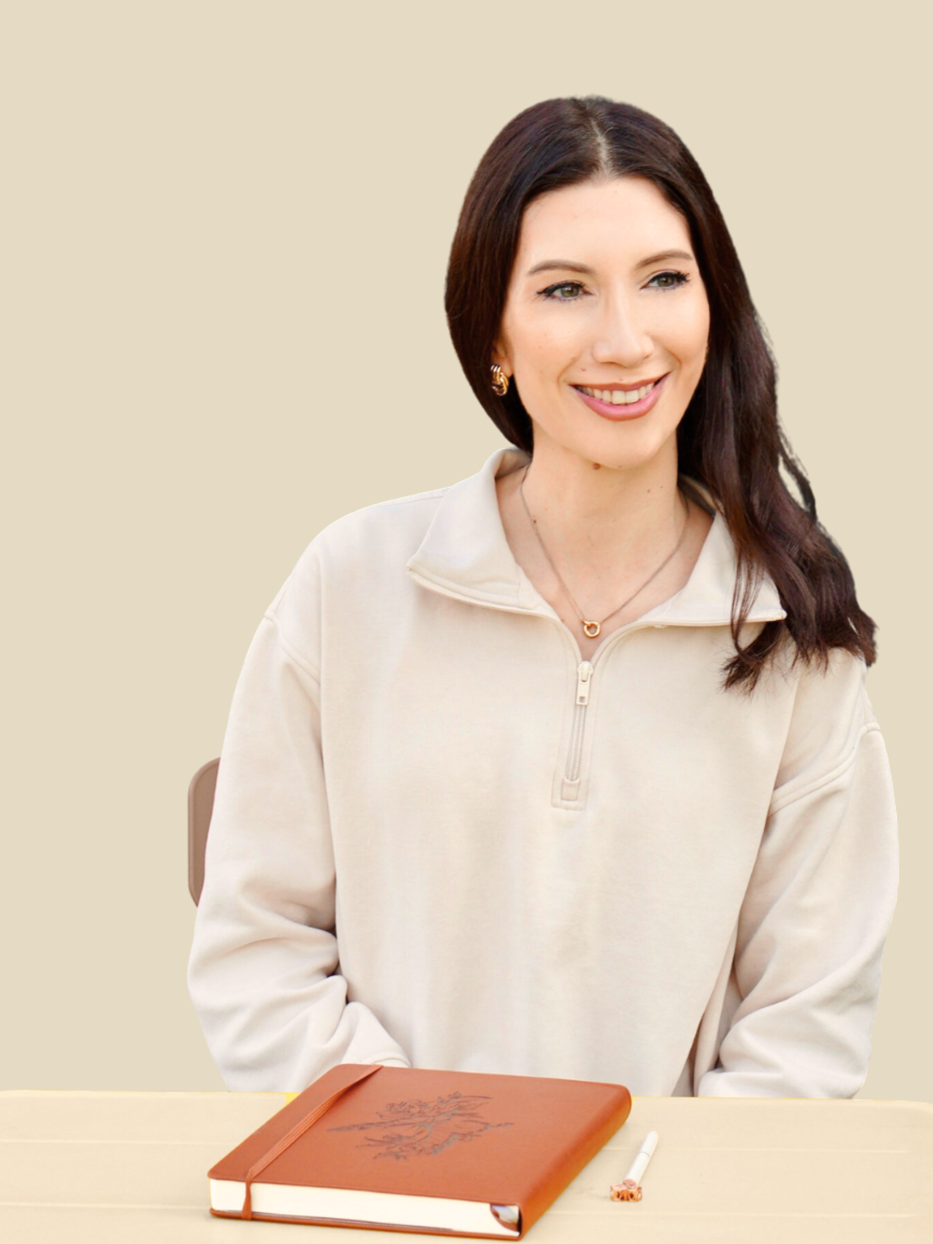 Darya at her desk — coach and founder of Butterfly Born, with journal and pen